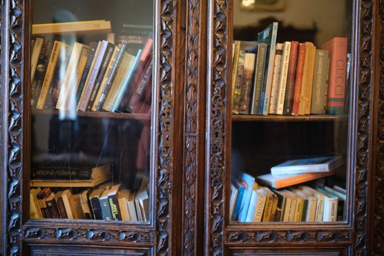 Ornately carved wooden bookshelf filled with assorted books, creating an inviting literary atmosphere.