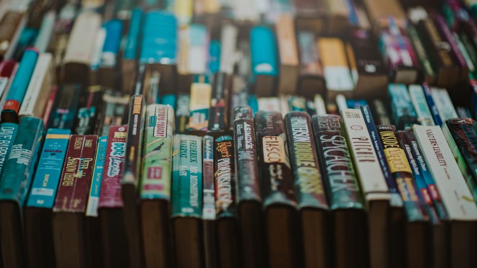 A detailed shot of antique leather-bound books stacked closely. Perfect for historical or literary themes.